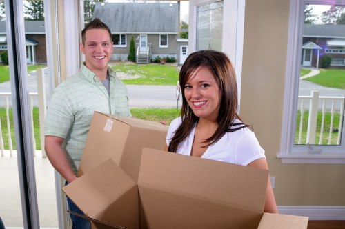 Local movers loading household items into a removals van in Cardiff