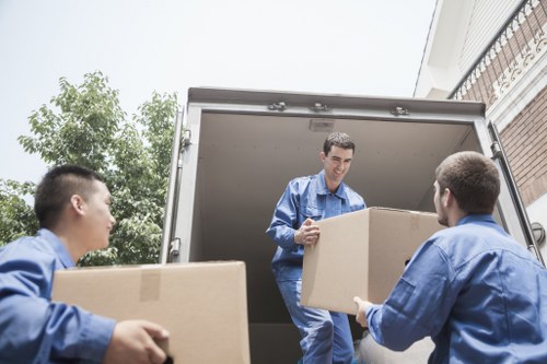 Labelled office boxes and furniture arranged for a move in Cardiff